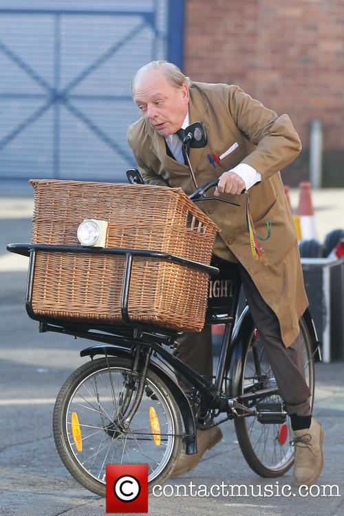 David Jason riding bicycle on 'Still Open All Hours' set