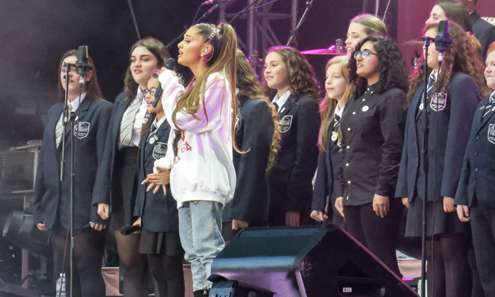 Ariana Grande performs with a children's choir